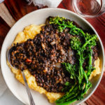 bbq lentils over cheese grits with a broccoli robe garnish